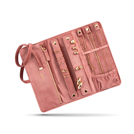 Dust and Rock Jewellery Wrap – pink suede-style foldable travel organiser with compartments for necklaces, earrings, rings, and bracelets; features zip pocket, snap closures, and soft lining to protect jewellery while travelling or at home.