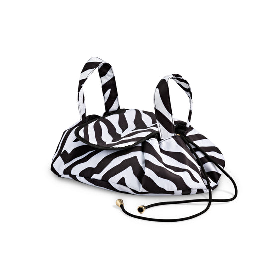 Dust and Rock Barrel Bag – 'Sirius' edition in zebra print; closed drawstring makeup organiser with sturdy handles and compact shape. Stylish and practical for storing toiletries, skincare, or cosmetics on the go.