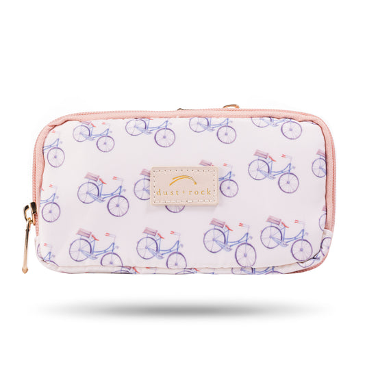 Dust and Rock Original Wrist Pocket – 'Ride With Me' edition with vintage-style bicycle print and pink trim; wearable wrist wallet ideal for cycling, walking, travel, and hands-free everyday use for women on the go.
